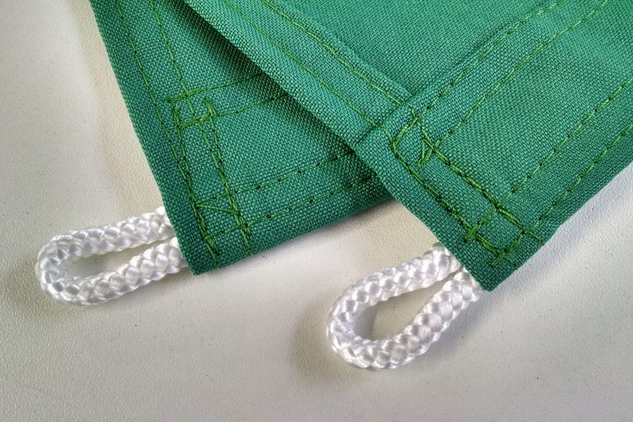 A close-up of green canvas and cord stitching.