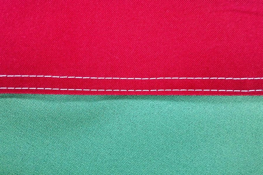 A red and green fabric seam.