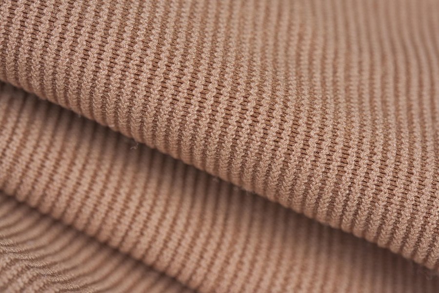 A close-up of a beige ribbed knit.