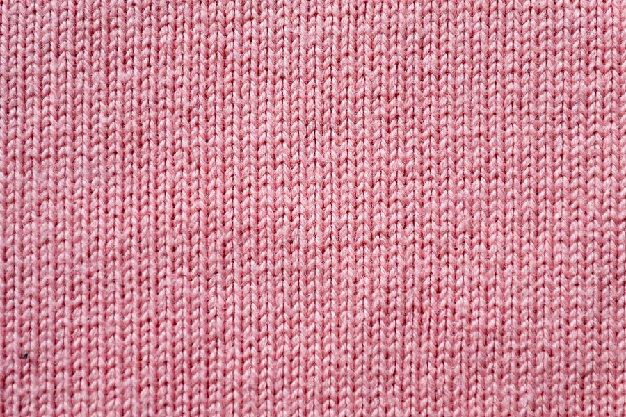 A close-up of a fine pink knit.