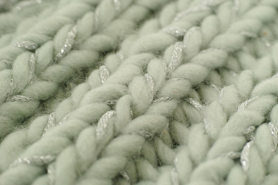 A close-up of a cream chunky knit.