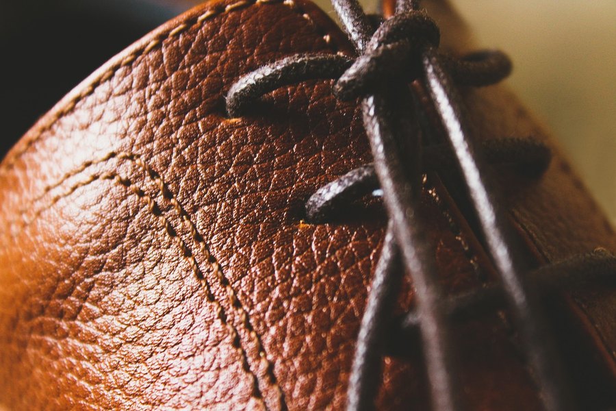 A close-up of a leather shoe with visible stitching.