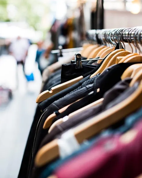 Rows of clothing on rails inside a shop.