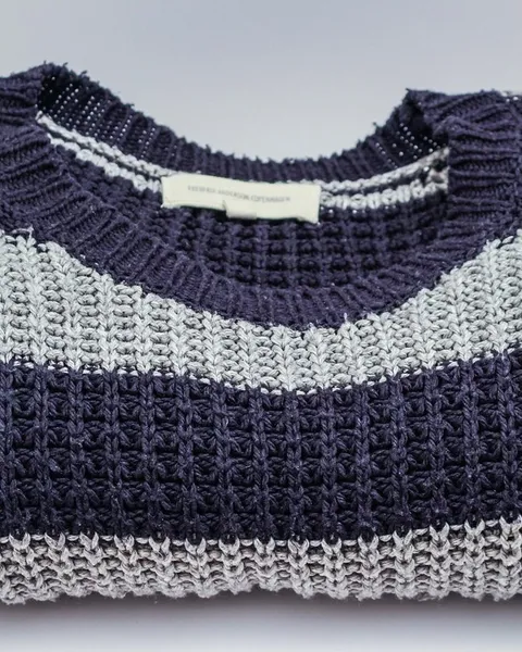 A striped navy and cream knit folded flat.