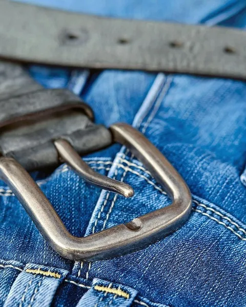 A denim waistband with a leather belt.
