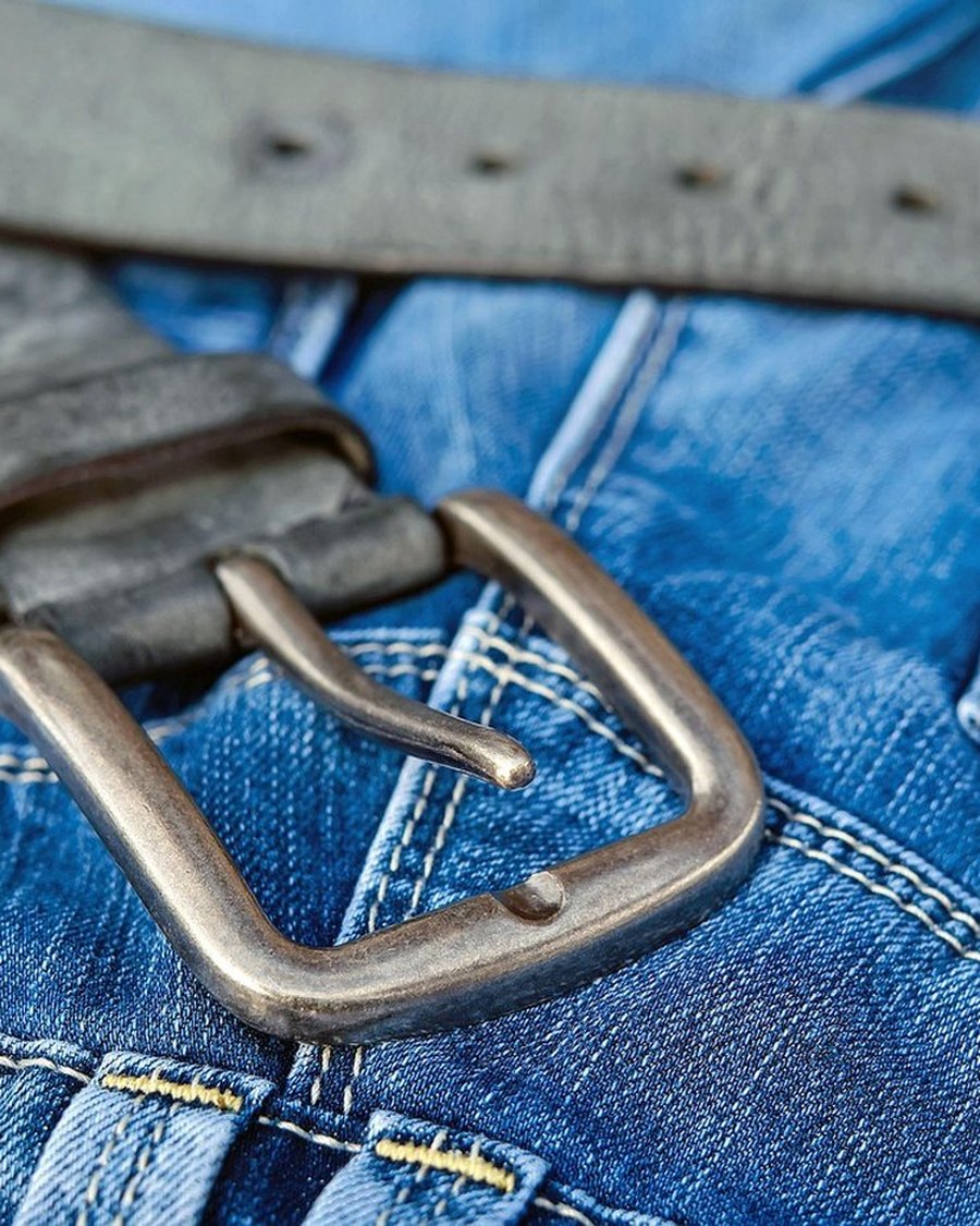 A denim waistband with a leather belt.